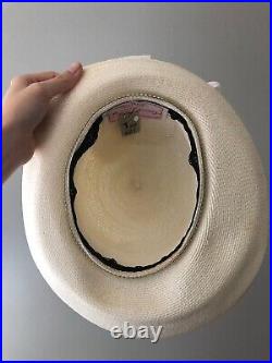 Vintage woman's beige hat decorated with white bow. Brand George Zamau'l, Straw