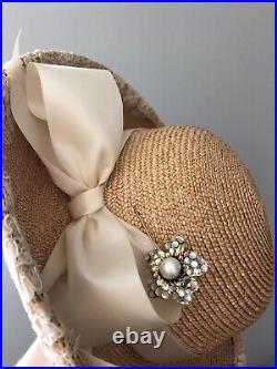 Vintage woman's beige hat with a bow and brooch. Brand Frank Olive, Straw