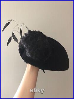 Vintage woman's black hat with a different types of feather. Brand Mr. John, Wool