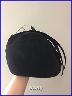 Vintage woman's black hat with a different types of feather. Brand Mr. John, Wool