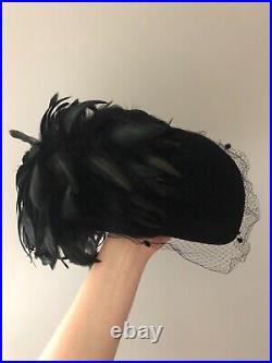 Vintage woman's black hat with a fine mesh and feathers. Brand Don Anderson, Wool