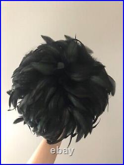 Vintage woman's black hat with a fine mesh and feathers. Brand Don Anderson, Wool