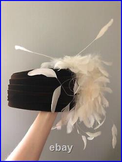 Vintage woman's black hat with a white feathers. Brand Chapeau Creation