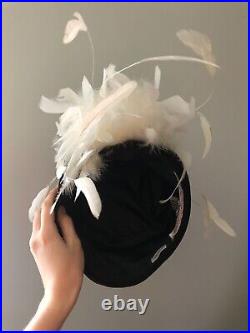 Vintage woman's black hat with a white feathers. Brand Chapeau Creation