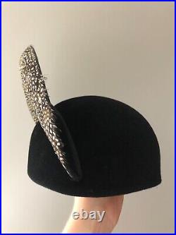 Vintage woman's black hat with different types of feathers. Brand Jack McConnell