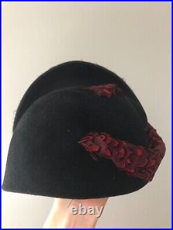 Vintage woman's black hat with different types of feathers. Brand Jack McConnell