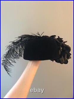 Vintage woman's black hat with feathers, roses and sequins. Brand Donna Vina