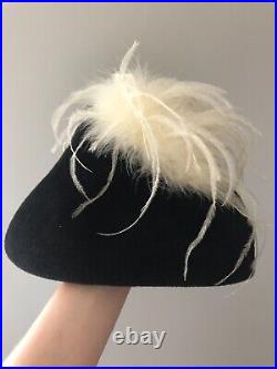 Vintage woman's black triangular hat with white feathers. Brand Sheryl's, Wool