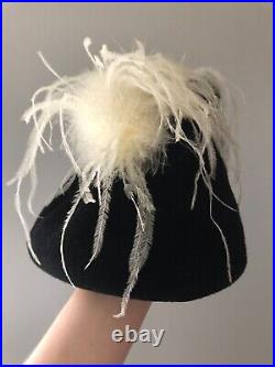 Vintage woman's black triangular hat with white feathers. Brand Sheryl's, Wool