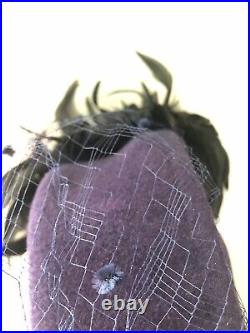 Vintage woman's blue hat with black feathers and a fine mesh. Brand Don Anderson