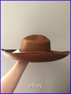 Vintage woman's brown hat with flowers and small bow. Brand Toucan, Straw