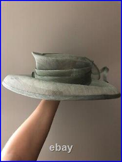 Vintage woman's green hat with decor and feathers. Brand August HAT Company