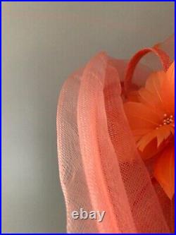 Vintage woman's peach hat with beautiful flower and decor. Brand Giovannio, Straw