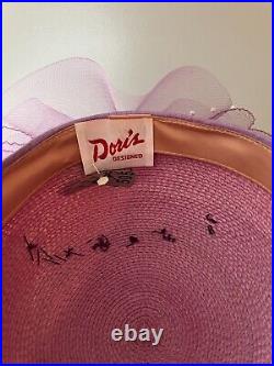 Vintage woman's pink hat with purple bow and with decor. Brand Doris, Straw