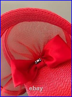 Vintage woman's red hat with a large decor and bow. Brand Jody J, Straw